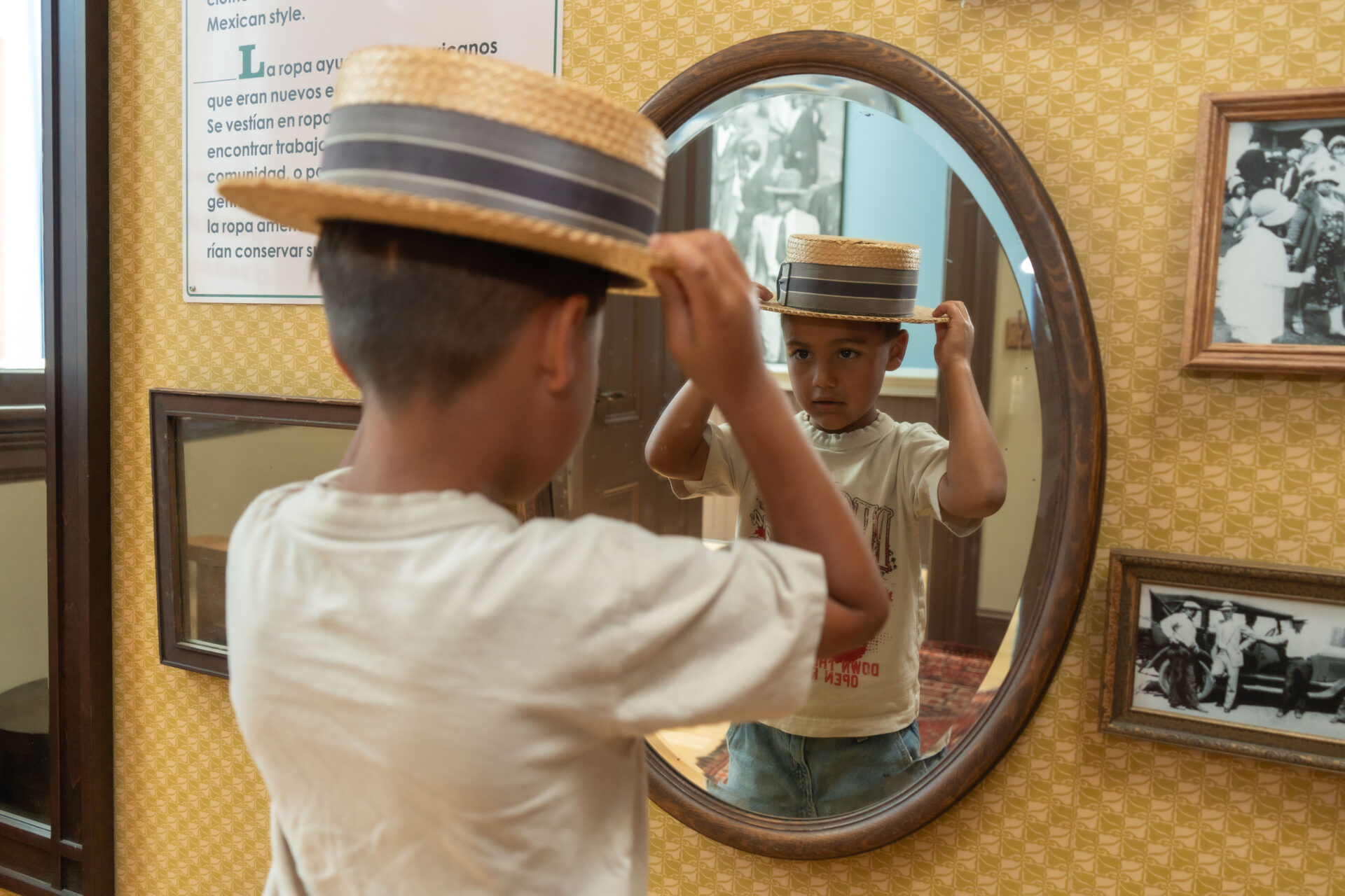 Your child wearing a 1920's hat looking through a mirror.